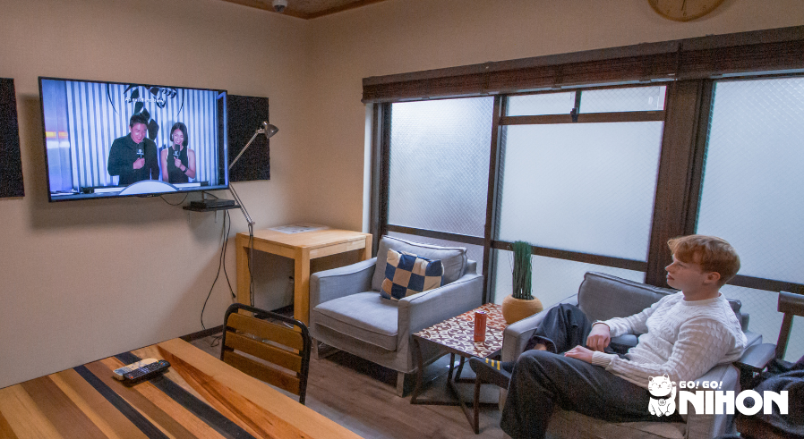 Student in share house watching TV