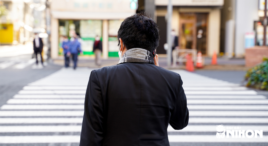 A man on the phone crossing the street