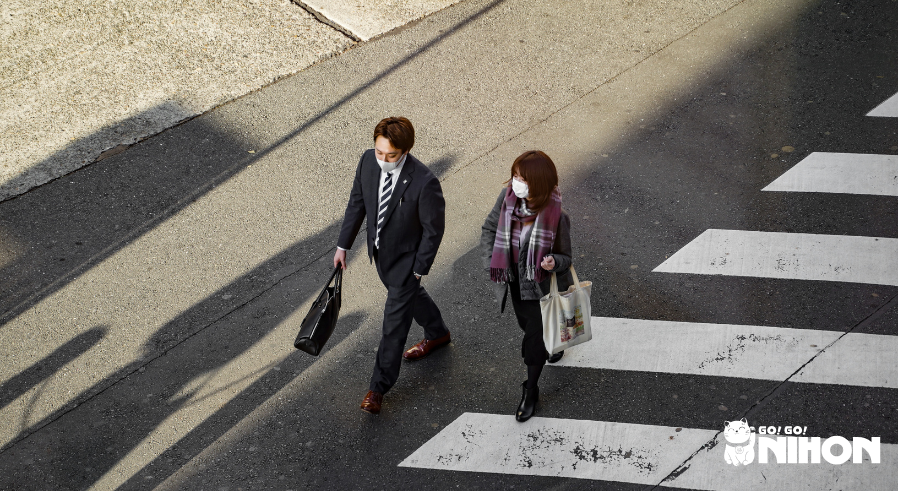 Two people crossing the road