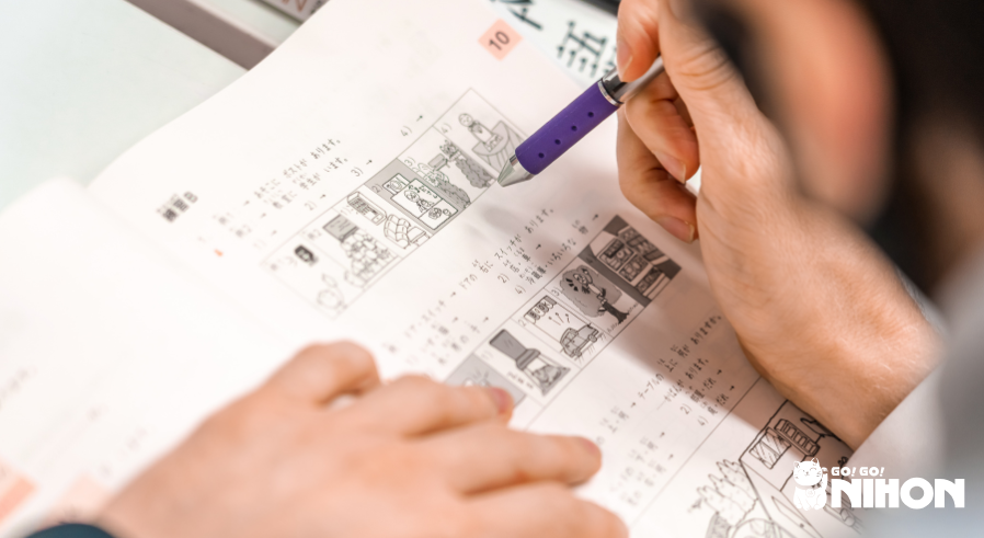 Student studying Japanese from a textbook at a Japanese language school