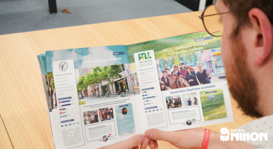 A student looking at a brochure and trying to choose a Japanese language school