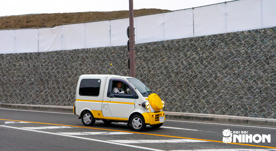 man driving small car in Japan