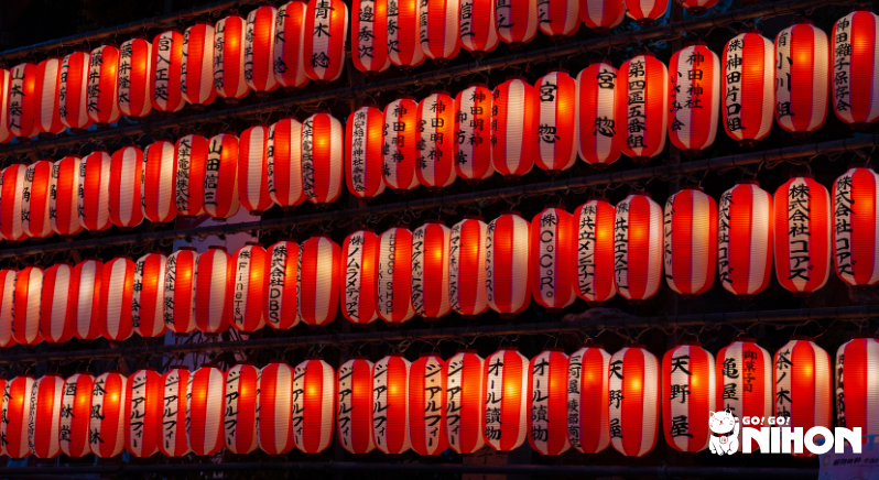 rows of red lit up lanterns at obon celebration at night