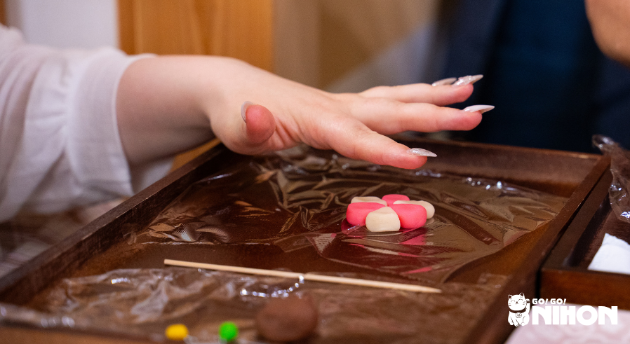 person making wagashi sweet on study trip activity
