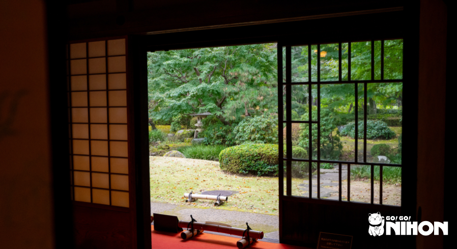 view of traditional japanese garden from inside a traditional japanese house