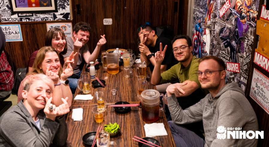 a group of study trippers making friends while studying abroad in Japan at an izakaya