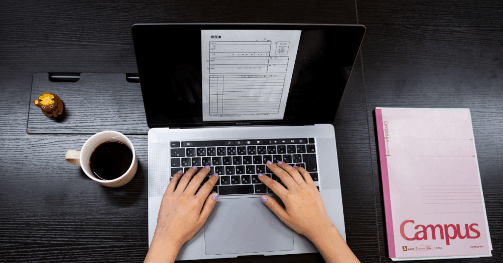 flat lay of laptop, notebook, and coffee