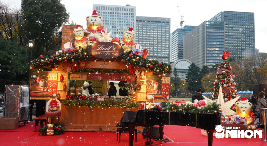 Lindt stall at a Christmas market while it is snowing