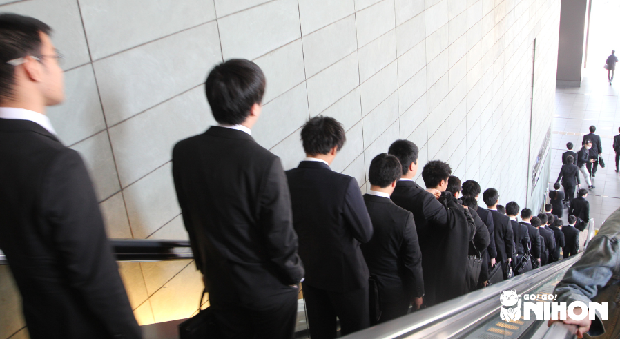 people riding an escalator in japan