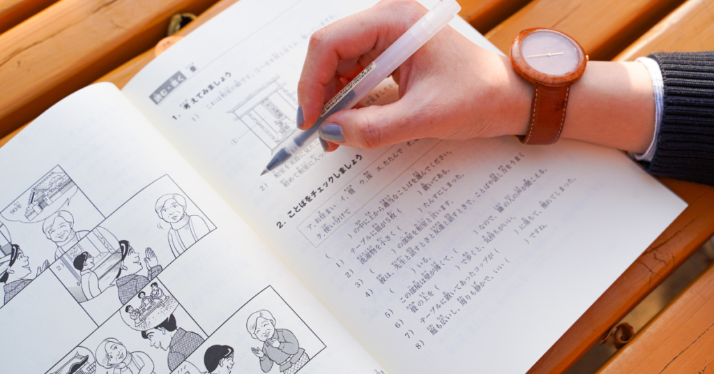 person studying Japanese from a textbook