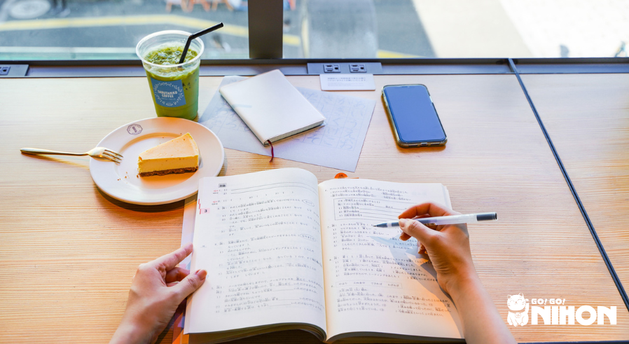 A person studying Japanese at a cafe
