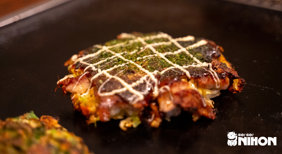 Okonomiyaki Osaka style on a grill, regional Japanese food from Osaka
