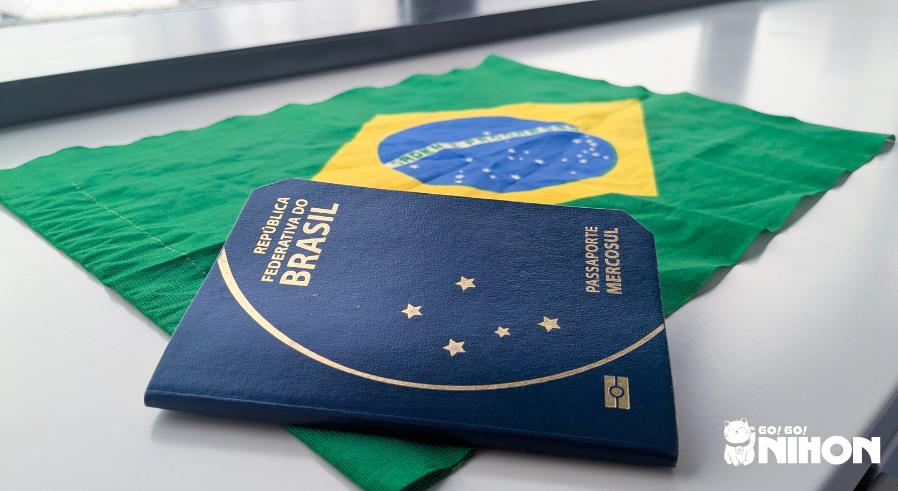 A Brazilian passport on top of a Brazilian flag