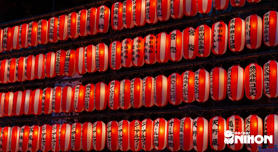 Rows of illuminated red lanterns at night during an Obon celebration in Japanese summer