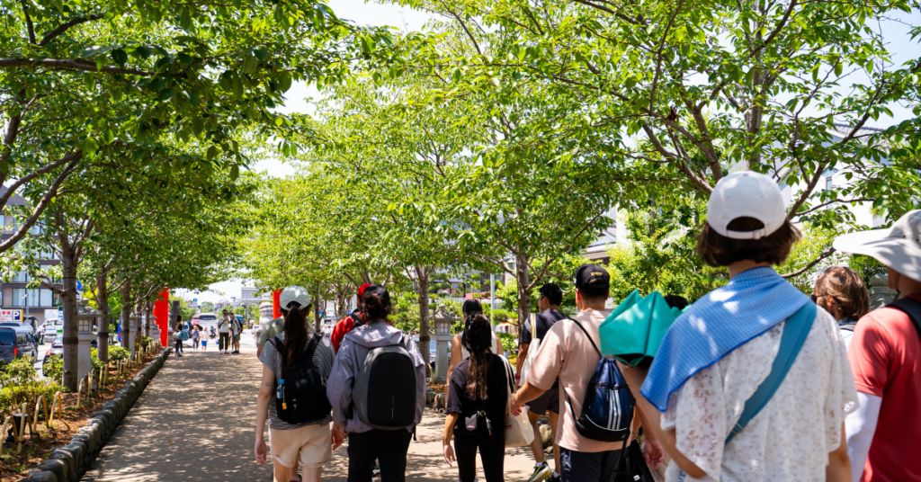 a group of people walking outside in the summer in Japan